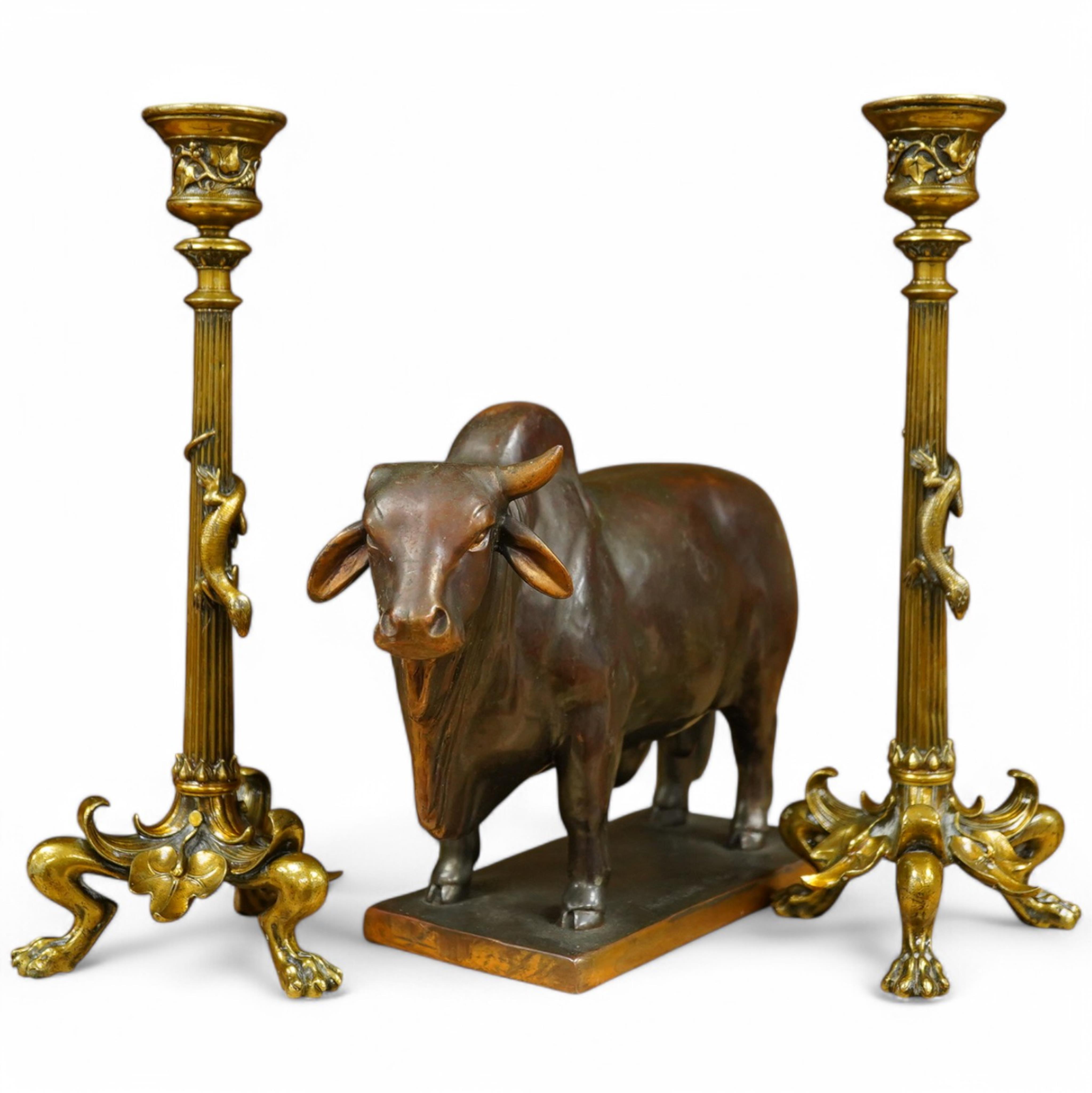 A patinated copper study, 'American Brahman', inscribed EtC, together with a pair of 19th century ormolu candlesticks, largest 30cm high. Condition - fair, bull missing one horn